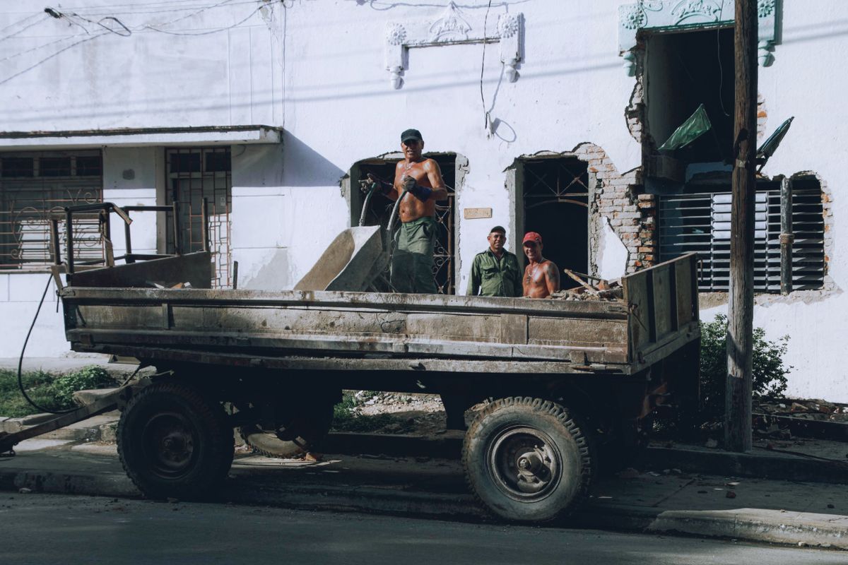 Crew loading debris into a truck