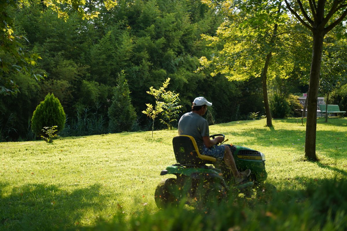 Landscaper mowing a lawn